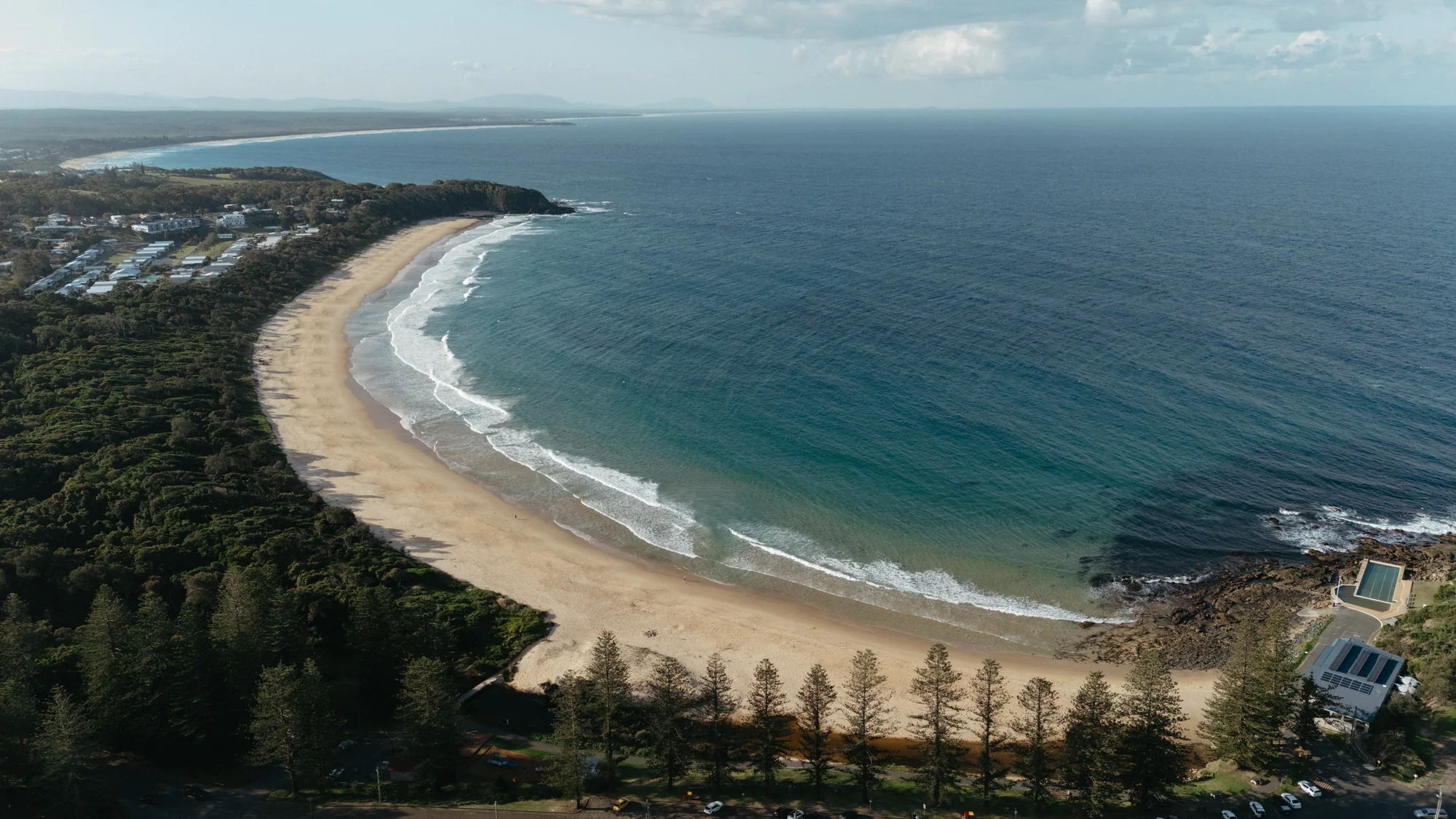 The sweeping bay and headland at Black Head from above