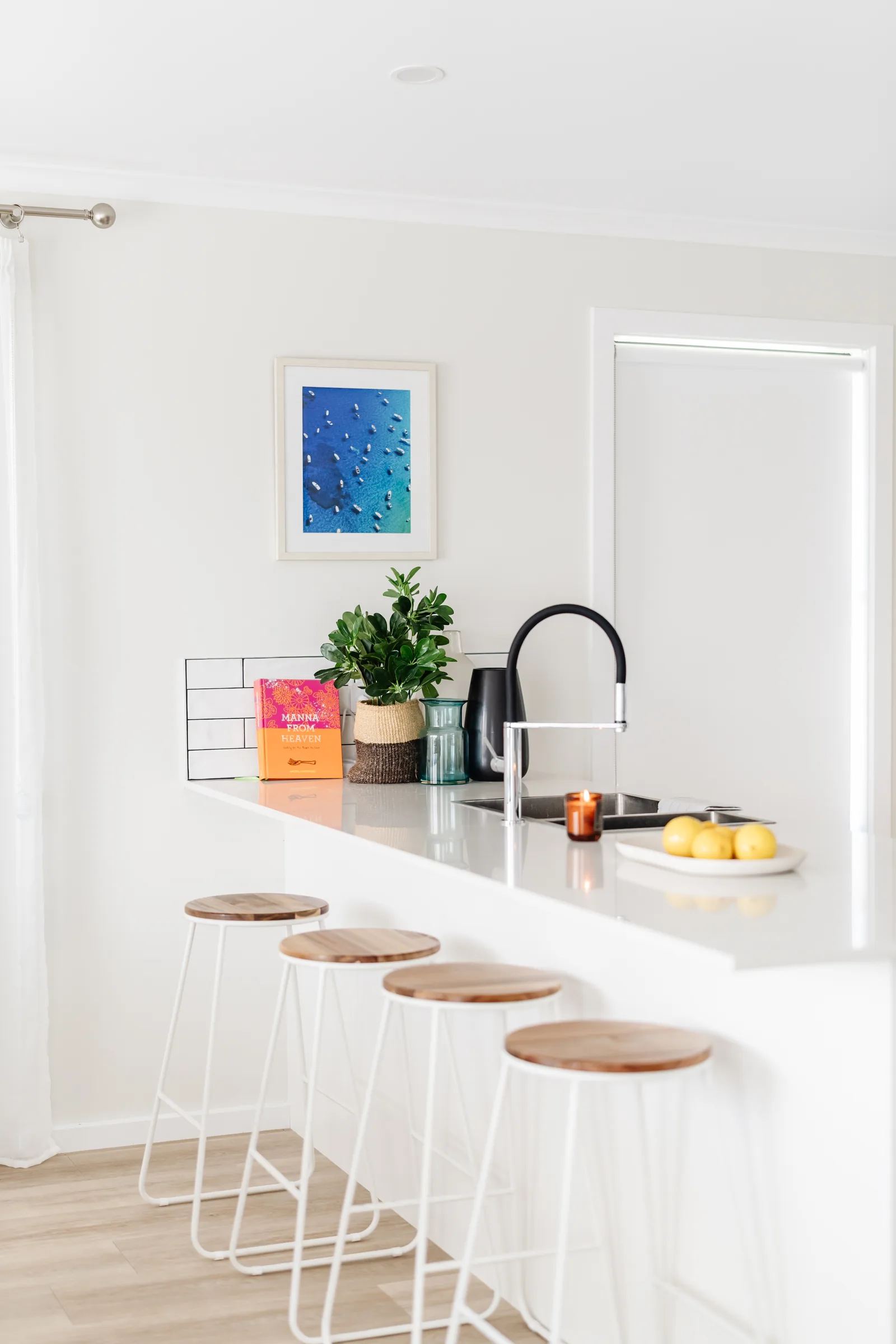 Kitchen with breakfast bar and coastal artwork
