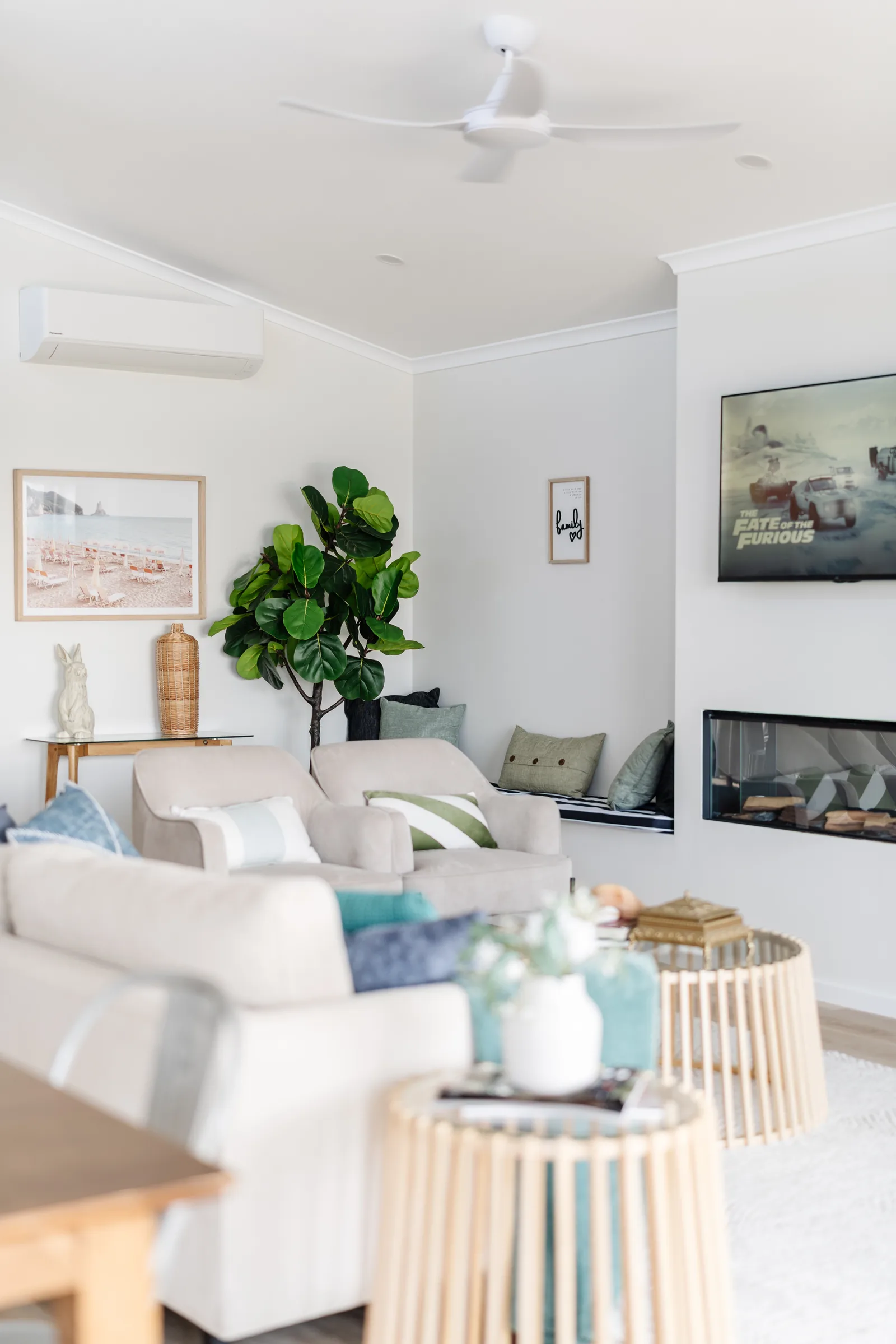 Living area with linear fireplace and fiddle-leaf fig