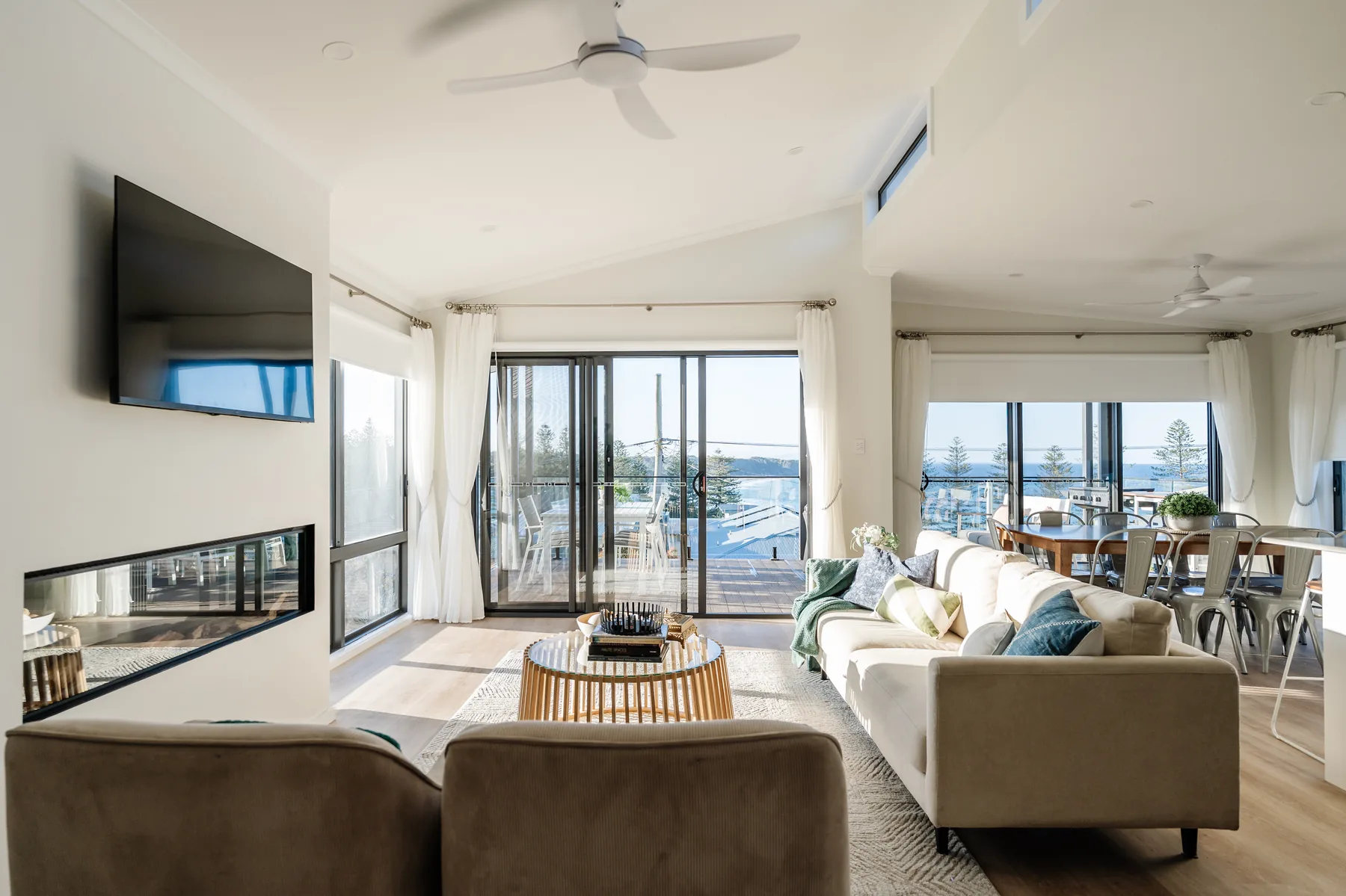 Main living room opening to the ocean-view deck